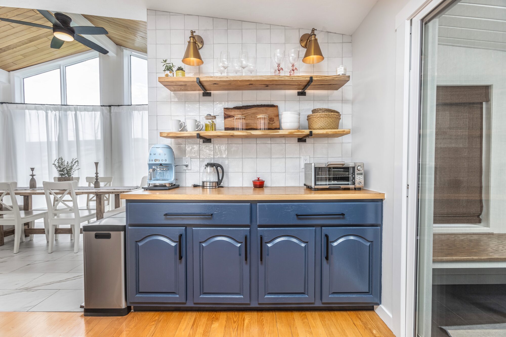 Coffee bar with brass sconces and open shelves.