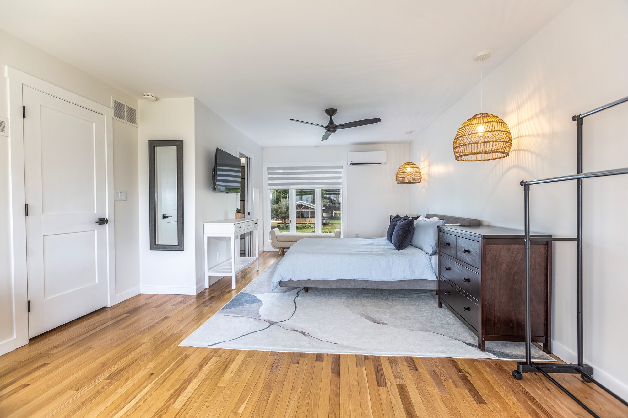 The upstairs loft with a queen bed, ceiling fan, and pendant lights.