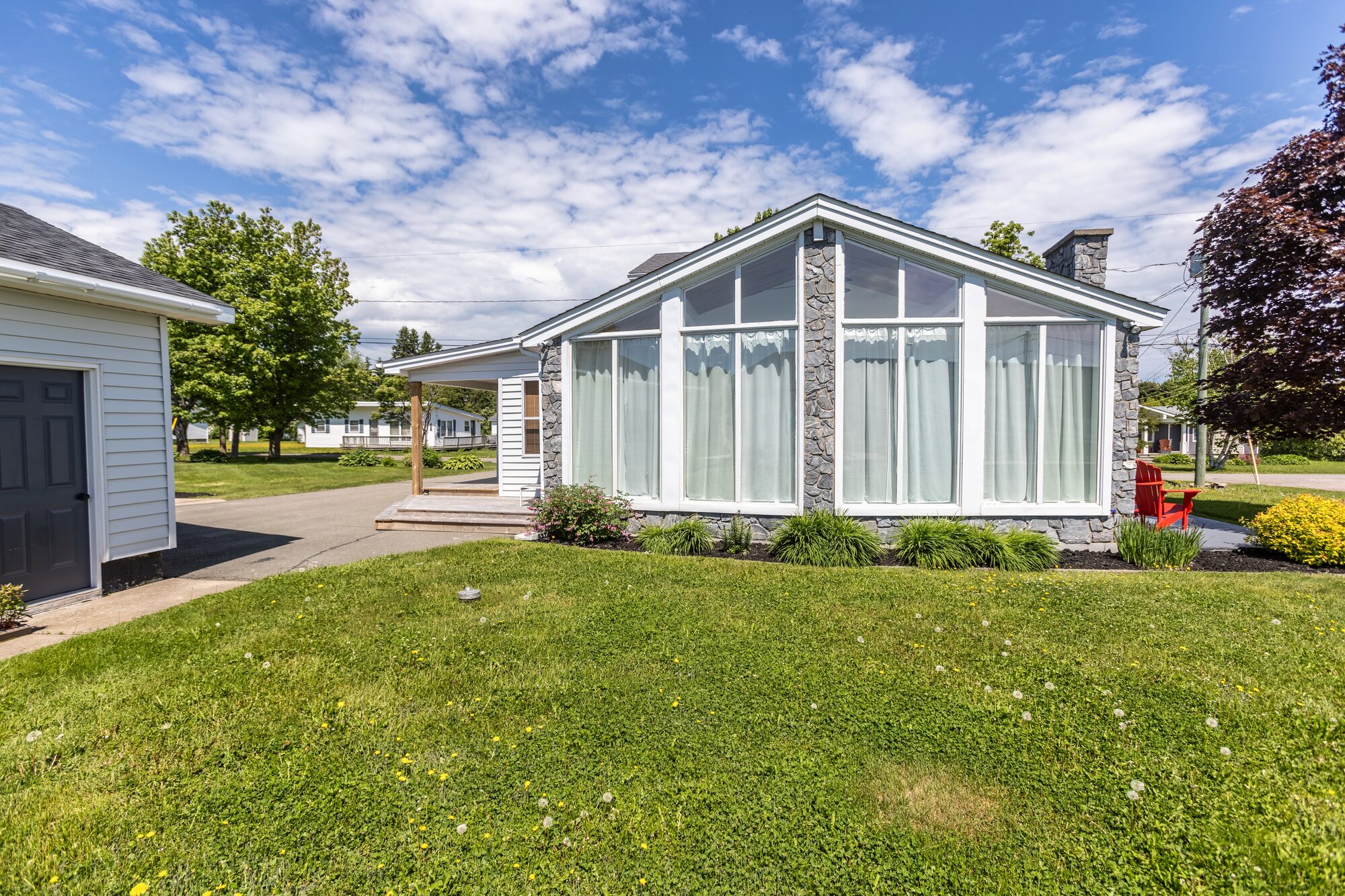 Window-side rocking chair with a partial view of the water.