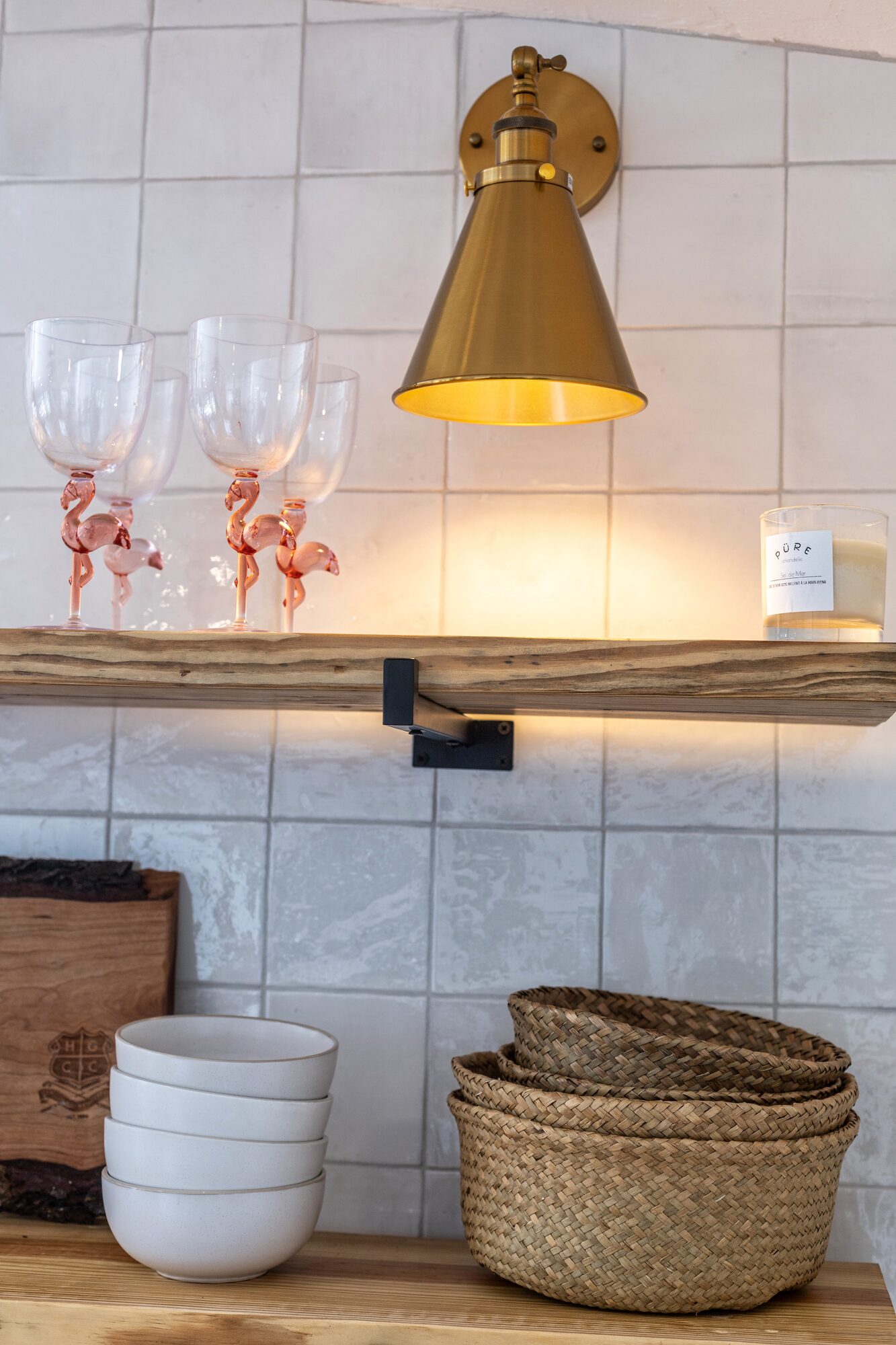 Detail: pink flamingo wine glasses on the open kitchen shelves.